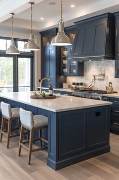 a large kitchen with blue cabinets and white counter tops, along with bar stools