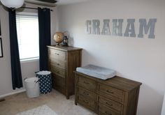 a baby's room with crib, dresser and window