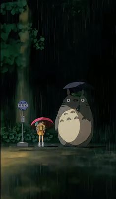 a person holding an umbrella standing next to a cartoon character in the rain at night