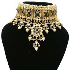 "Simple Fancy Bridal Wedding Designer Meena Kundan necklace Set Contains a awesome choker necklace that Fixs the Neck, a Pair of Earrings embedded with Semi-precious Stones like Pearl,glass. This product is handmade & hence the product can be non-uniform & vary in color & texture. Color : Black Gorgeous Meena Kundan Gold Plated Necklace jewelry Set 1.Set consists of Necklace, Earrings 2. Necklace Size:(4\"L X 6.5\"W) 3.Necklace Weight: 150 Gm 4.Earrings Length:2\" EXPEDITED DELIVERY Heavy Kundan Choker For Receptions, Kundan Tilla Choker Necklace For Reception, Bollywood Bridal Kundan Necklace Jeweled, Bollywood Style Kundan Bridal Necklace With Jewels, Bollywood Style Bridal Kundan Necklace Jeweled, Bollywood Style Bridal Kundan Necklace, Bollywood Style Jeweled Necklaces For Reception, Heavy Choker For Festivals And Reception, Heavy Choker For Reception And Festivals