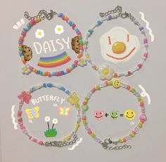 the four bracelets are decorated with smiley faces, eggs, and rainbow - colored beads