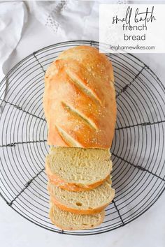 a loaf of bread sitting on top of a wire rack next to a white towel