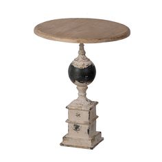 an old wooden table with black and white decorations on it's pedestal, against a white background