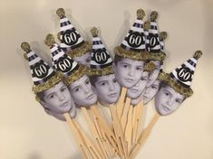 a group of people with hats on top of toothpicks in front of a wall