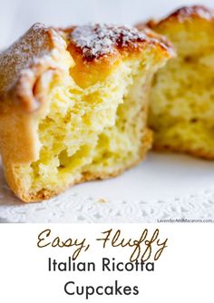 an italian ricotta cupcake with powdered sugar on top is cut in half