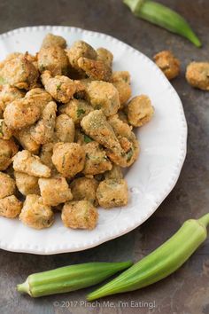 a white plate topped with fried food next to celery