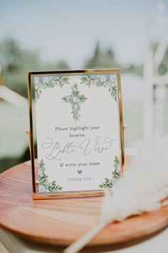 a table with a sign and some feathers on it