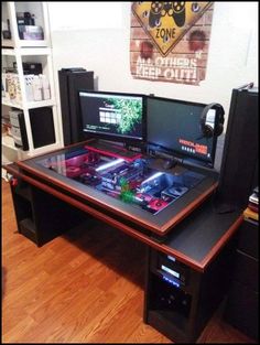 a computer desk with two monitors on it