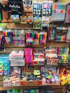 there are many different types of pens and pencils on the shelves in this store