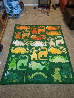 a green rug with numbers and dinosaurs on it