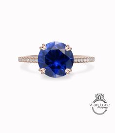 a blue sapphire and diamond ring on a white background