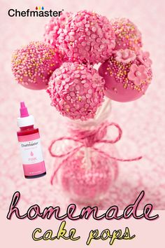 pink cake pops with sprinkles in a vase