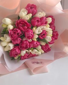 a bouquet of pink and white tulips