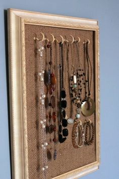 a wall mounted jewelry rack with many different necklaces