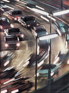 many cars are driving down the busy highway at night, with lights shining on them