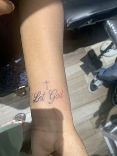 a person with a tattoo on their arm that says let god in red and blue