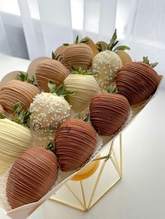 chocolate covered strawberries are arranged in a triangle on a plate with gold trimmings