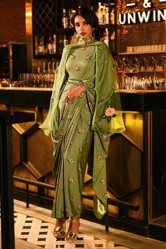 Green saree dress with floral print and pleated sleeves. Paired with embroidered cape and belt.
Components:3
Pattern:Printed
Type of Work:Floral
Neckline:Saree Gown: Round, Cape: Mandarin collar
Sleeve Type:Saree Gown: Three quarter, Cape: Flared sleeves
Fabric:Polycrepe
Color:Green
Other Details:
Note: Pant worn by the model is not for sale
Occasion:Sangeet - Aza Fashions Seafoam Dress, Saree Gowns, Cape For Women, Embroidered Cape, Dress With Cape, Floral Saree, Gown For Women, Saree Gown, Drape Saree