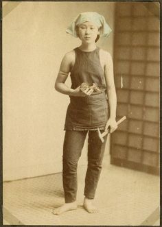 an old black and white photo of a woman in overalls, holding a hammer