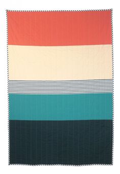 a multicolored blanket is folded on top of a white surface with black, orange, and green stripes