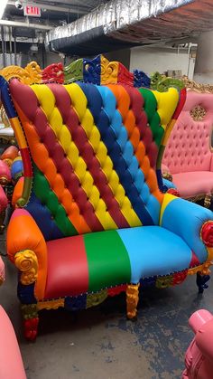 colorful couches and chairs are on display in a warehouse