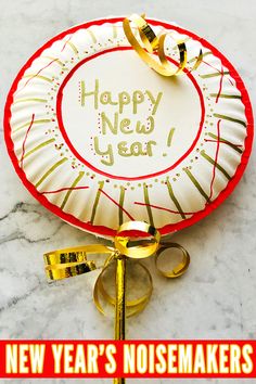 a new year's noisemakers paper plate on a marble table