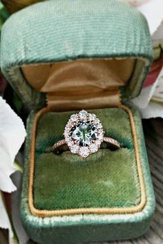 an engagement ring in a green velvet box