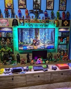 there is a large television in the room with many action figures on top of it