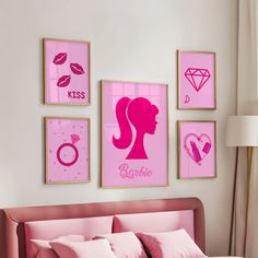 a bedroom with pink decor and pictures on the wall