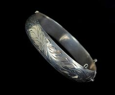 "Vintage Mid-Century Sterling Burkhardt Birks Canada Engraved Floral Thick Bangle Bracelet 7\" Item offered is an antique sterling engraved etched Burkhardt floral bangle bracelet. This bracelet consists of gorgeous etched floral designs. The clasp is a tab insert clasp. There is no safety chain attached. Condition is good, with age related wear. Inside is marked \"Sterling\" and \"B\". Please see photos provided as they are an extension of our written description. Measurements: Bracelet length: Formal Etched Bangle, Engraved Bracelets For Weddings And Festivals, Engraved Bracelets For Wedding And Festivals, Etched Round Cuff Bracelet For Wedding, Wedding Etched Round Cuff Bracelet, Engraved Cuff Bracelet For Wedding And Festivals, Etched Bangle Bracelets For Wedding, Engraved Bangle Bracelet For Wedding, Etched Bangle For Wedding