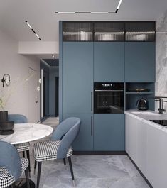 a kitchen with blue cabinets and marble counter tops