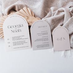 the wedding stationery is laid out next to each other on top of a blanket