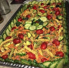 a large metal pan filled with pasta and veggies