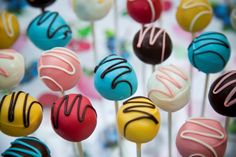 there are many colorful cake pops on the stick