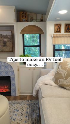 a living room filled with furniture and a fire place next to a window on top of a rug