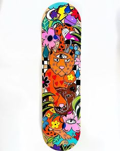 a skateboard with an image of a cat and flowers on the bottom half of it