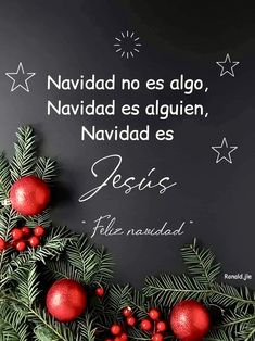 a christmas card with holly branches and red balls on the bottom, in spanish language