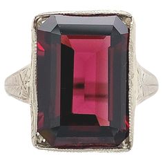 Vintage 14K white gold ring featuring an emerald cut rhodolite garnet. This deep raspberry dark pinkish-red color garnet weighs 8.35 carats and measures about 14mm x 10mm. The mounting is all hand engraved. The ring originally accommodated a square corner stone and we set a cut corner stone. The ring fits a size 5.5 finger, weighs 3.06dwt and dates from the 1920's with a new stone. Hand Engraved Rings, 5 Fingers, Engraved Ring, Rose Rouge, Rhodolite Garnet, Gold Hands, 14k White Gold Ring, Ring Fit, White Gold Ring