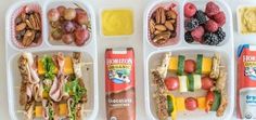 three plastic trays filled with different types of food and drinks on top of each other