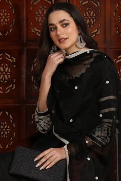 Black Silk Blend Solid Embroidered Anarkali Suit Set Expertly crafted with a luxurious silk blend and intricate embroidery, this Anarkali suit set is the epitome of elegance and opulence. It's the perfect addition to your wardrobe for any special occasion, offering a timeless and sophisticated look that is sure to turn heads. Style NoteComplete the LookThis suit set is versatile enough to be dressed up or down. For a daytime event, pair it with sandals and a statement scarf. For a night out, add Short Kurtis, Statement Scarf, Embroidered Anarkali, Dhoti Pants, Anarkali Suit, Intricate Embroidery, End Of Season Sale, Suit Set, New Instagram