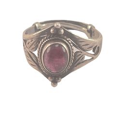 This vintage sterling silver ring features an intricate design with a beautiful ruby gemstone at its center. Crafted with attention to detail, the ring's delicate patterns and the rich red hue of the ruby create a stunning focal point. Ideal for those who appreciate timeless elegance and unique jewelry pieces, this ring is both a statement and a keepsake. * Sterling silver construction * Ruby gemstone centerpiece * Intricate design with detailed patterns * Vintage aesthetic * Size 8.5 * Elegant and unique Features: * Boho Size: 8.5 Adjustable Condition: Pre-Owned Good Oval Ruby Ring With Intricate Design, Ornate Round Ruby Ring, Vintage Garnet Ruby Ring With Intricate Design, Ornate Ruby Ring With Filigree Detail, Oval Engraved Ruby Ring, Oval Ruby Ring With Filigree, Oval Ruby Ring Engraved, Ornate Silver Ruby Ring, Ornate Ruby Ring With Gemstone