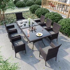 an outdoor dining table and chairs set up on a patio