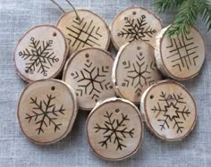 a white plate topped with wooden slices covered in snowflakes