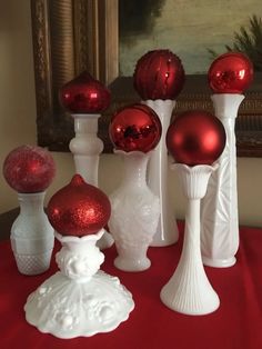 red and white glass vases sitting on top of a table