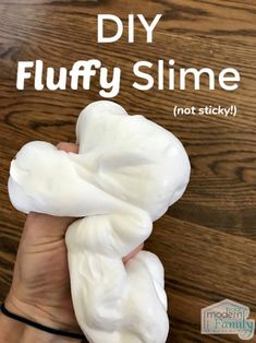 someone is holding some white stuff in their hand with the words diy fluffy slime not sticky