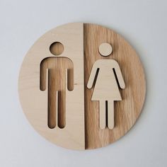 a wooden cutout of a man and woman standing next to each other on a white background