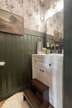 a bathroom with green paneling and white sink, wooden steps leading up to the toilet