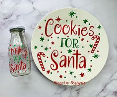 a cookie for santa plate next to a glass jar