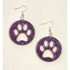 pair of earrings with purple glitter and paw print