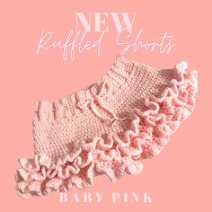 a baby pink ruffled shorts with the words, new knitted shorts on it